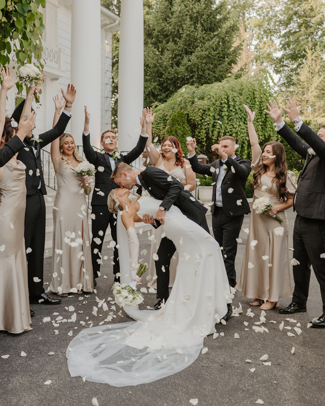 Newlyweds celebrating with their wedding party at The Briarcliff Manor in Westchester, New York